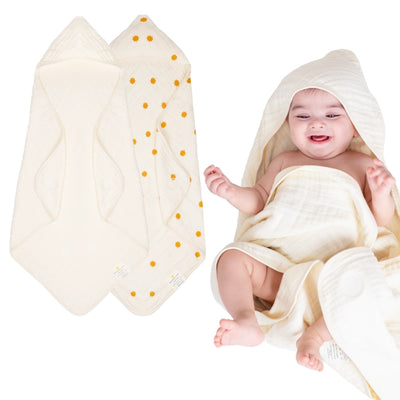 Baby wrapped in a hooded muslin cotton bath towel designed for gentle drying after bath time. The soft, breathable fabric keeps baby warm and comfortable while the hood helps dry the head quickly. Large absorbent towel designed to wrap newborns and infants securely for cozy post-bath care.