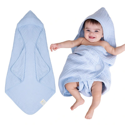 Baby wrapped in a hooded muslin cotton bath towel designed for gentle drying after bath time. The soft, breathable fabric keeps baby warm and comfortable while the hood helps dry the head quickly. Large absorbent towel designed to wrap newborns and infants securely for cozy post-bath care.