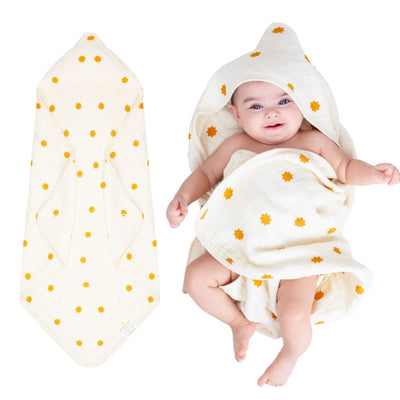 Baby wrapped in a hooded muslin cotton bath towel designed for gentle drying after bath time. The soft, breathable fabric keeps baby warm and comfortable while the hood helps dry the head quickly. Large absorbent towel designed to wrap newborns and infants securely for cozy post-bath care.