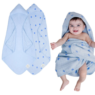 Baby wrapped in a hooded muslin cotton bath towel designed for gentle drying after bath time. The soft, breathable fabric keeps baby warm and comfortable while the hood helps dry the head quickly. Large absorbent towel designed to wrap newborns and infants securely for cozy post-bath care.