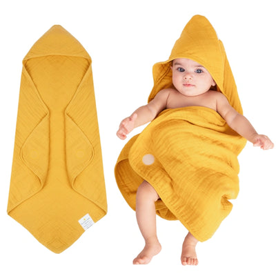 Baby wrapped in a hooded muslin cotton bath towel designed for gentle drying after bath time. The soft, breathable fabric keeps baby warm and comfortable while the hood helps dry the head quickly. Large absorbent towel designed to wrap newborns and infants securely for cozy post-bath care.