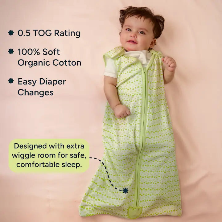 Baby lying wearing a Nintara Baby sleep sack. Text highlights 0.5 TOG rating, 100% soft organic cotton, easy diaper changes, and extra wiggle room at the bottom for safe, comfortable sleep