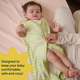 A parent unzips a Nintara Baby sleep sack from the bottom for a diaper change while baby lies on a soft surface with legs raised.A parent unzips a Nintara Baby sleep sack from the bottom for a diaper change while baby lies on a soft surface with legs raised. Text reads: Designed to keep your baby comfortable, safe and cozy.