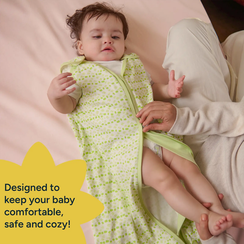 A parent unzips a Nintara Baby sleep sack from the bottom for a diaper change while baby lies on a soft surface with legs raised.A parent unzips a Nintara Baby sleep sack from the bottom for a diaper change while baby lies on a soft surface with legs raised. Text reads: Designed to keep your baby comfortable, safe and cozy.