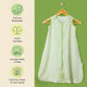 Nintara Baby sleep sack on a wooden hanger. Features icons highlighting soft and breathable fabric, GOTS certified organic cotton, lovingly made in India, and sourced from field to home.