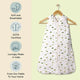 Nintara Baby sleep sack on a wooden hanger. Features icons highlighting soft and breathable fabric, GOTS certified organic cotton, lovingly made in India, and sourced from field to home.