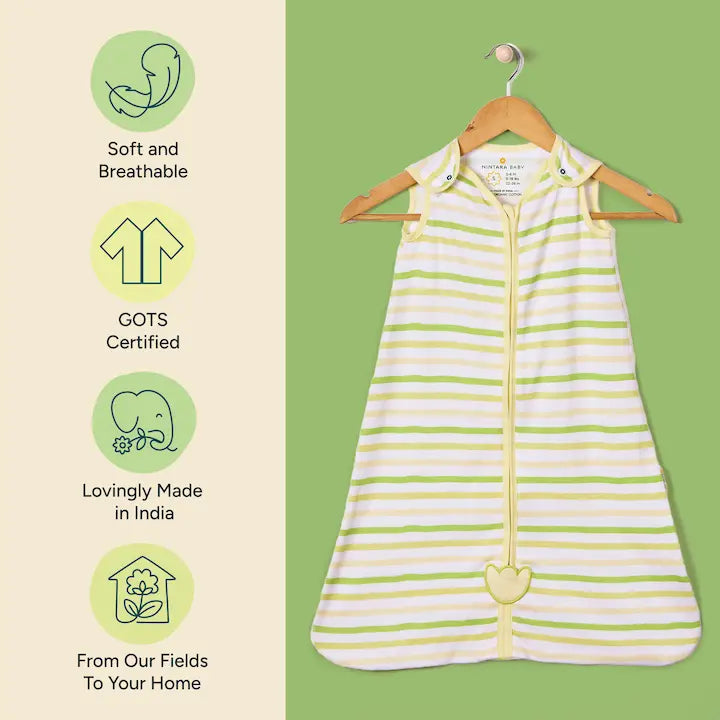 Nintara Baby sleep sack on a wooden hanger. Features icons highlighting soft and breathable fabric, GOTS certified organic cotton and sourced from field to home.