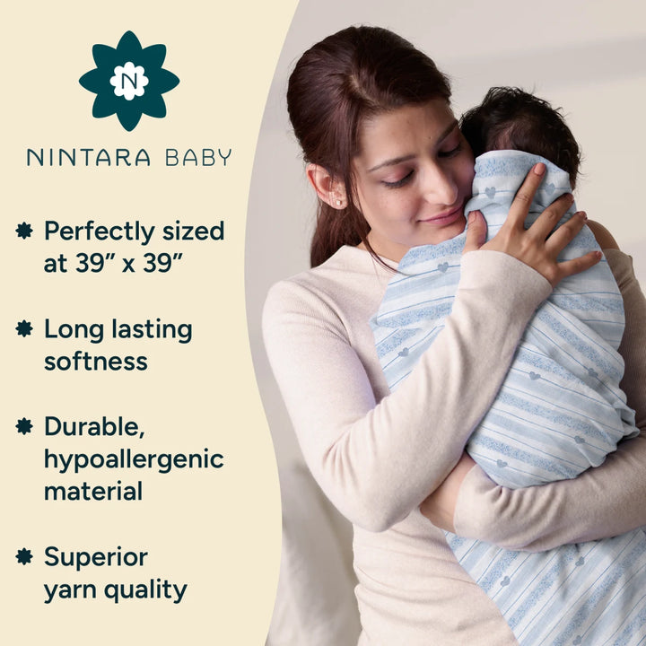 A mother lovingly holds her baby wrapped in a soft, light blue swaddle made from 100% organic muslin cotton. The image focuses on the tender connection between mother and child while showcasing the product's premium quality. The swaddle’s design emphasizes comfort, softness, and durability, with key features like hypoallergenic material and superior yarn quality highlighted in the accompanying text.
