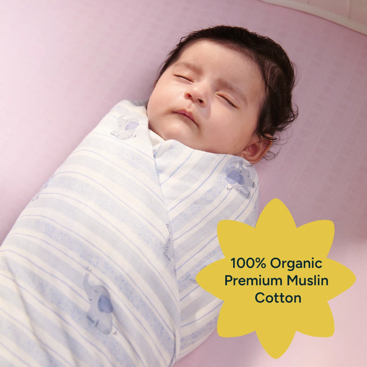A baby is shown sleeping peacefully, wrapped in a soft, striped swaddle featuring an adorable elephant print. The swaddle, made of 100% organic premium muslin cotton, offers the perfect combination of softness, breathability, and warmth, ideal for newborns. The image radiates a calming, nurturing atmosphere, focusing on the baby’s contentment and the high-quality fabric of the swaddle