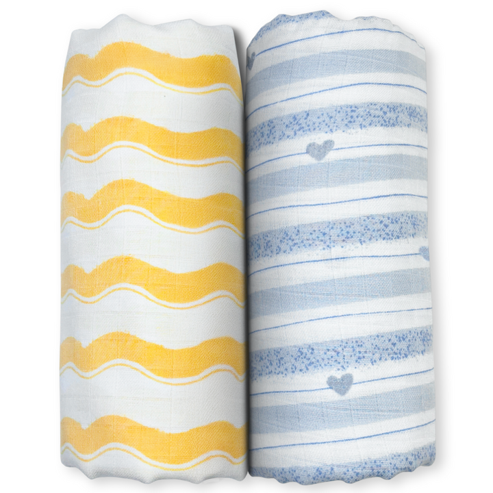 Two rolled-up baby blankets with yellow wavy stripes and blue hearts in a Playful Patterns set