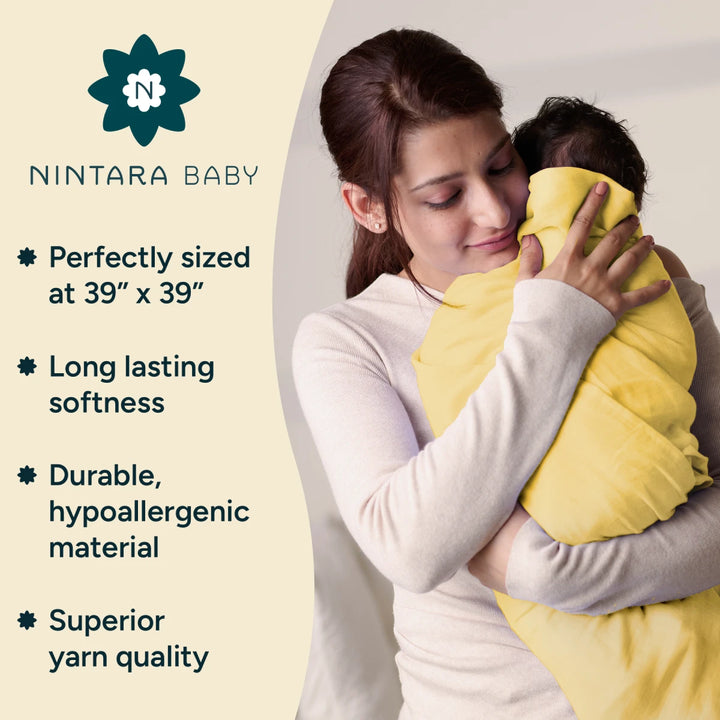 This image depicts a mother lovingly holding her baby, who is wrapped in a yellow Nintara Baby swaddle. The soft and comforting embrace emphasizes the product's promise of long-lasting softness and hypoallergenic materials. The image features key product points such as perfect sizing (39- x 39-), durability, superior yarn quality, and the long-lasting softness of the swaddle. The neutral background adds focus to the mother-baby bond.